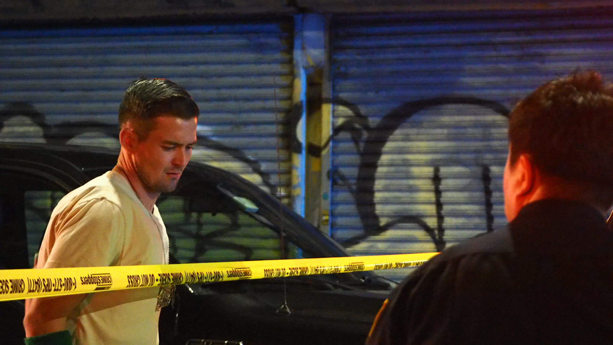 A plainclothes officer watches the perimeter.